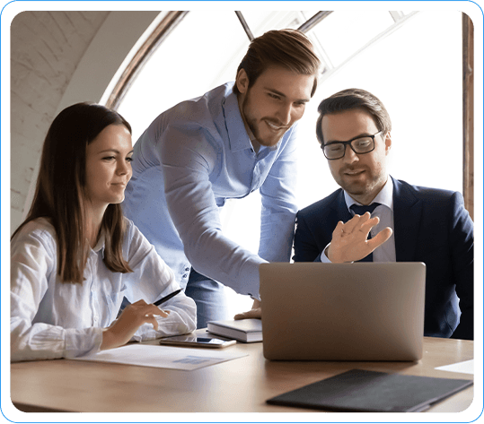 Business Team Collaborating And Discussing Ideas While Looking At A Laptop In A Modern Office