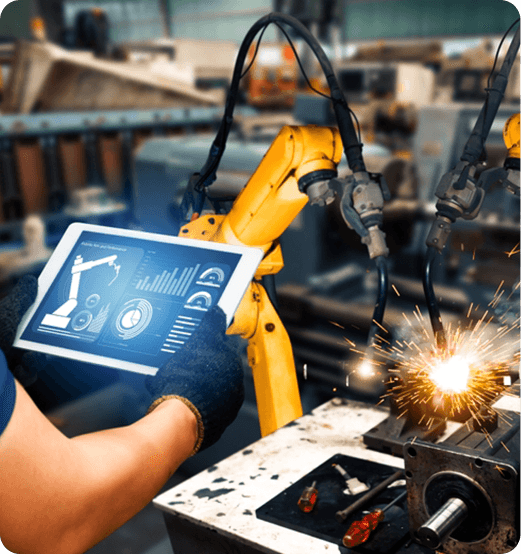 Engineer Monitoring Robotic Welding Arm With Tablet, Showcasing IT Solutions For Manufacturing Efficiency