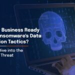 Person using laptop with digital skull graphic illustrating ransomware data extortion tactics and evolving cybersecurity threats